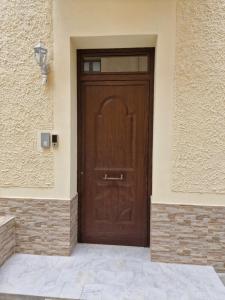 a wooden door on the side of a building at Casa Mia in Scilla