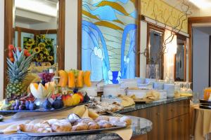 un buffet con fruta y otros alimentos en un mostrador en Hotel Miramare, en Lignano Sabbiadoro