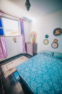 a bedroom with a blue bed and a window at Moroccan Family House in Agadir