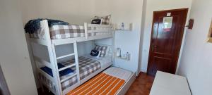 Postel nebo postele na pokoji v ubytování Pequena Baleia