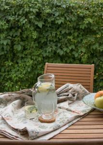 a table with a pitcher of water and glasses on it at Design Coastal Garden Apartment in Split