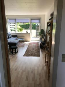 a living room with a couch and a table at Langø, ferielejlighed in Nakskov