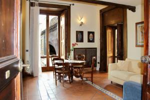 a living room with a table and chairs and a couch at Palazzo Ammone - Sedil Dominova in Sorrento