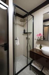 a bathroom with a shower and a sink at Design Coastal Garden Apartment in Split