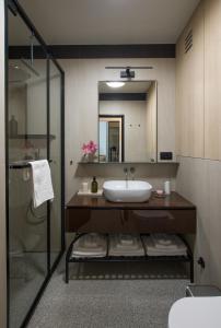 a bathroom with a sink and a mirror at Design Coastal Garden Apartment in Split
