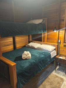 a bedroom with a bunk bed with shoes on it at Chalés no meu quintal in Lauro Müller