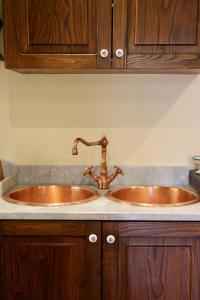 a bathroom counter with two sinks and wooden cabinets at Palazzo Ammone - Sedil Dominova in Sorrento +31 photos