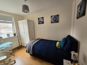 a bedroom with a bed and a desk and a window at City Nest. in Dublin