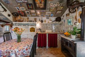 a kitchen with a table with a vase of flowers on it at Karla planinska kuća in Baška Voda