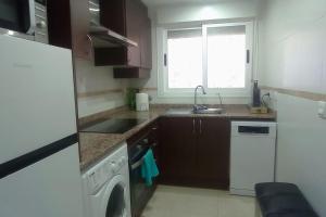 a small kitchen with a sink and a dishwasher at Las mejores vistas de Oropesa in El Borseral