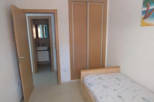 a small bedroom with a bed and a bathroom at Las mejores vistas de Oropesa in El Borseral +5 photos