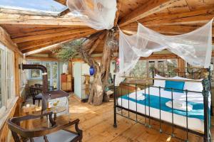 a bedroom with a bed and a wooden ceiling at Margaritis's Treehouse in Paramonas