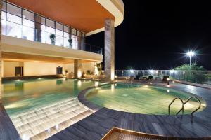 a swimming pool in a building at night at Victory Hotel Vung Tau in Vung Tau