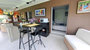 a room with a table and a room with a bed at CHAMBRE PRIVEE AVEC SALON, garage voiture, vélos, motos in Tourville-sur-Arques