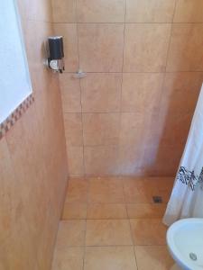 a bathroom with a shower with a toilet and a sink at Cabañas Puertas del Sol in La Rioja