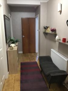 a hallway with a door and a bench and a rug at Kings Lynn 1 in Kings Lynn