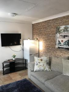 a living room with a couch and a refrigerator at Kings Lynn 1 in Kings Lynn