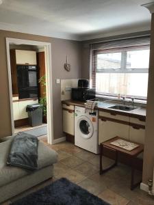 a kitchen with a washing machine and a sink at Kings Lynn 1 in Kings Lynn