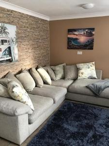 a living room with a couch and a brick wall at Kings Lynn 1 in Kings Lynn