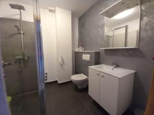 a bathroom with a toilet and a sink and a shower at AS apartmani "Pistachio" in Peroj +15 photos
