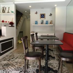 a dining room with a table and chairs and a couch at Ten Rooms Istanbul Hotel in Istanbul