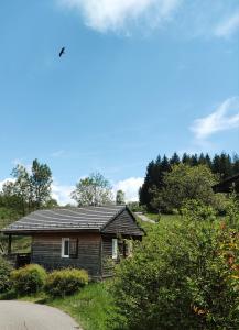 mały dom z blaszanym dachem na polu w obiekcie Camping Onlycamp Les Petites Roches w mieście Saint-Hilaire