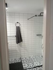 a bathroom with a shower with a towel on it at LimonoSpito in Koroni +50 photos