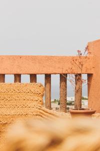 a wooden fence with a tree in a pot at Panorama Guesthouse in Agadir