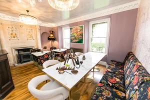 a living room with a table and chairs and a fireplace at The Burgoyne in Reeth