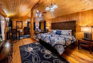 a bedroom with a bed in a room with wooden walls at Desert Rose Resort & Cabins in Bluff