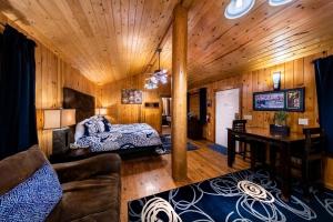 a bedroom with a bed and a desk in a room at Desert Rose Resort & Cabins in Bluff