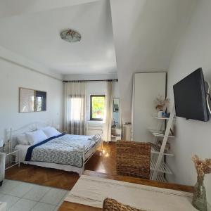 a bedroom with a bed and a flat screen tv at Apartments Ada in Rovinj