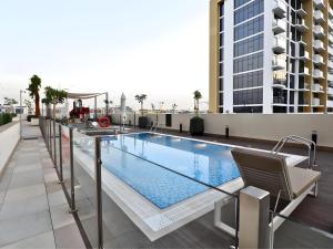 a swimming pool on the roof of a building at VESTA - Dubai Residence in Dubai