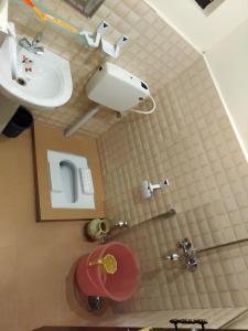 a bathroom with a sink and a toilet at Ghanche Inn Hotel in Dargai