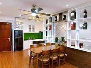 a kitchen with a table and chairs and a refrigerator at Homestay Hạ Long 3 phòng ngủ view biển in Ha Long