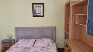 a bedroom with a bed and a picture on the wall at Apartament Gabriela in Mangalia