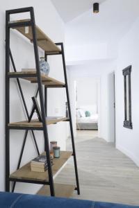 a ladder shelf in a room with a bedroom at The CLOCK in Voluntari