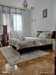 a bedroom with a bed and a wooden floor at Apartments Natali in Bar