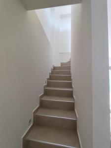 a staircase in a house with white walls at Villas EPTA KARPI Complex of 7 Luxury Villas in Skriperón