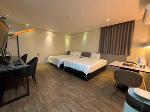 Postel nebo postele na pokoji v ubytování Cheonan K Hotel