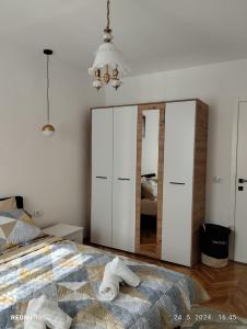 a bedroom with a bed and a large mirror at Apartments Natali in Bar
