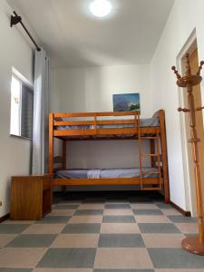 2 beliches num quarto com piso em xadrez em Suíte Família para até 4 pessoas em casa de praia em Bertioga