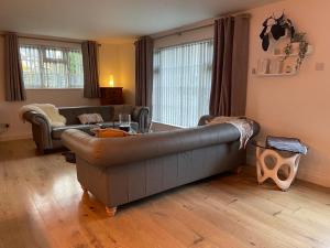 a living room with a couch and a table at Birch Villa in Aberystwyth