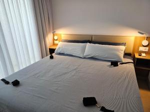 Un dormitorio con una cama grande con dos bolsas negras. en MAR BIANCO - Gay Men Only en Maspalomas