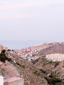 a city on top of a hill with buildings at Entire House with private Rooftop in Al Hoceïma