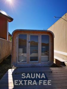 a sauna entrance sign in front of a building at Modern Rorbu Ryten 1 in Sund