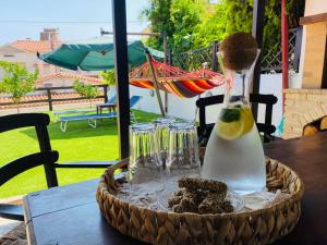 a table with a bottle of oil and some cookies at Aelia Cottage House in Khrónia