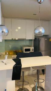 a kitchen with white cabinets and a white counter top at LIV@5 Condominium in Bangkok
