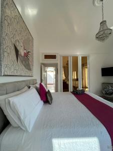 a bedroom with a large white bed with pillows at MARVELOUS SEA VIEW VILLA in Capri