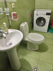 a bathroom with a toilet and a sink and a washing machine at birdhome in Tbilisi (Maria) in Tbilisi City +42 photos